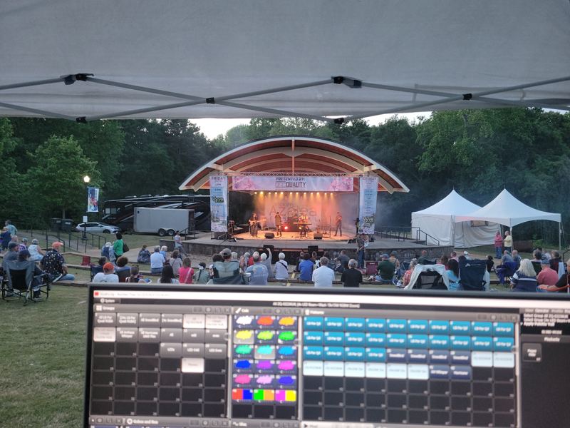 Amphitheater stage at dusk, seen over the lighting console