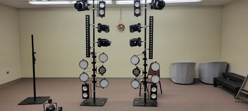 Lighting fixtures on stands being tested before a show